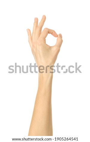 Ok sign. Woman hand gesturing isolated on white