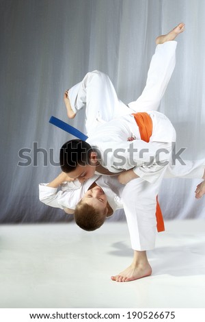Young athlete with an orange belt performs technique nage-waza Royalty-Free Stock Photo #190526675