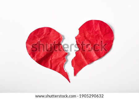 Pieces of crumpled and torn red heart shape paper isolated on white background. Broken heart concept. Royalty-Free Stock Photo #1905290632
