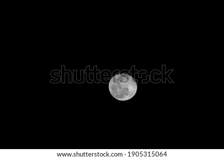 The first full moon of January 2021 also referred as the wolf moon. Bright moon on a dark sky.