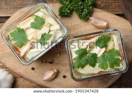 Delicious chicken aspic served on wooden board, top view