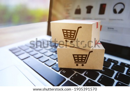 Parcel box on a laptop with Shopping service on the online website,E-commerce or online shopping concept.  Royalty-Free Stock Photo #1905391570