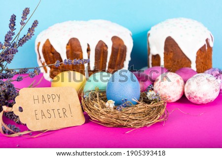 Colorful background with Easter eggs on pink and blue background. Happy Easter concept. Can be used as poster, background, holiday card. Flat lay, top view, copy space. 