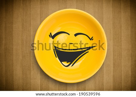 Happy smiley cartoon face on colorful dish plate and grungy background