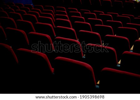 Texture with red chairs in an empty cinema or theater Royalty-Free Stock Photo #1905398698