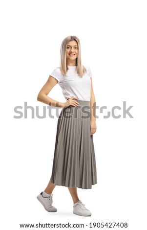 Full length portrait of a casual blond woman in a pleated skirt and white t-shirt isolated on white background Royalty-Free Stock Photo #1905427408