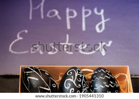 Easter egg with chalk on the background of a chalkboard with the text.