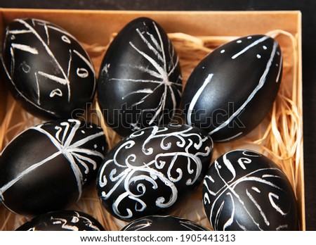 Creative trendy painted easter eggs on black background. Easter ideas. Background with easter eggs.