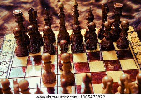 Vintage wooden chess set with queen gambit opening, close-up view of the chessboard.