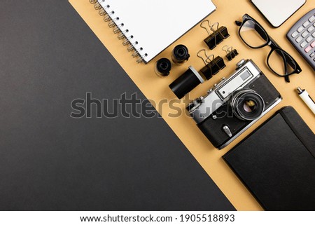 Workplace on black table of a creative designer or photographer with photography equipment. Stylish home studio concept flat lay of technology trends. Top view. Copy space. 