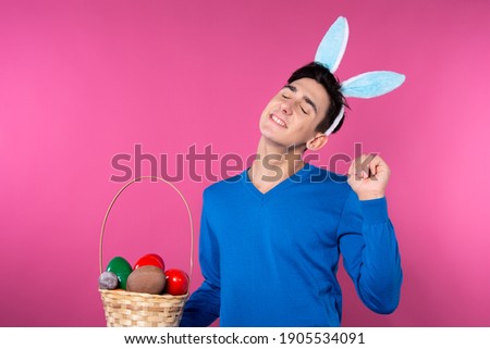 Handsome young man holding a basket of eggs. Easter and traditions. Religion and Faith.