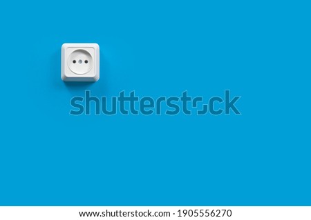 white electrical outlet on a blue wall, background