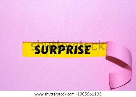 SURPRISE appearing behind torn paper. Business