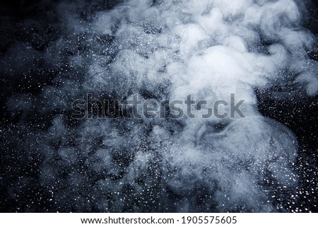 Abstract white smoke moves on black background. Beautiful art photo of swirling gray smoke.