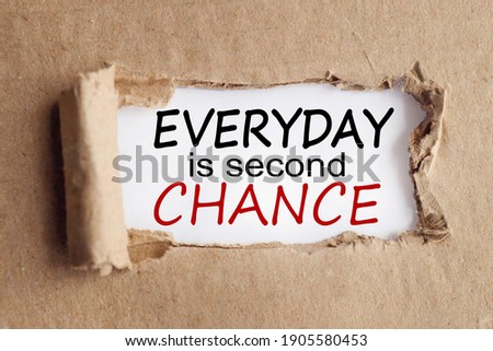 EVERYDAY IS SECOND CHANCE, text on white paper over torn paper background