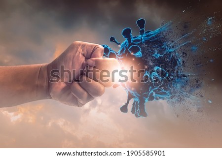 Hand punched fight attack to coronavirus,concept of fighting corona Virus or covid 19,exercise, health care, social distancing, innovations, vaccine and drug development, medicine and research. Royalty-Free Stock Photo #1905585901