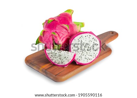 The dragon fruit is on a separate wooden cutting board on a white background with a cutting path.