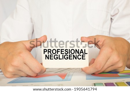 a man in the office holds a card with text PROFESSIONAL NEGLIGENCE . business concept