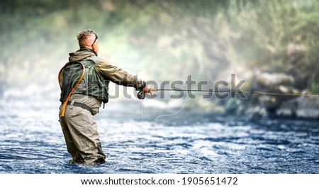 Fisherman hunting trouts in mountain river. Fishing net detail. Royalty-Free Stock Photo #1905651472