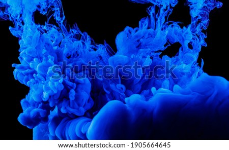 Abstract blue ink in water on a black background