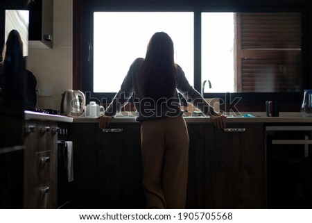 sad brunette woman thinking about problems in the kitchen, concept of depression and problems, selective focus. Royalty-Free Stock Photo #1905705568