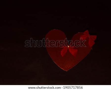 gold heart with red bows