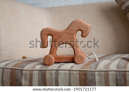 Wooden horse on wheels, children's toy, horizontal photo. 