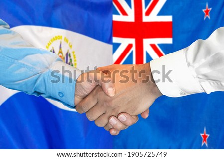Business handshake on the background of two flags. Men handshake on the background of the El Salvador and New Zealand flag. Support concept