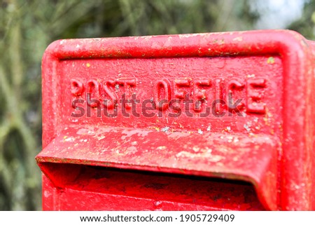 Red metal post box with the wording of Post Office