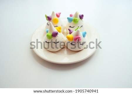 desserts meringue unicorns on a white plate