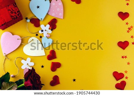 Top view of box, hearts and an envelope with free space for text on a pastel blue background. Mother's day concept. Flat lay, top view. Colored hearts tied together.