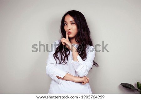 young asian woman doctor in white uniform gesturing positive on gray background, lifestyle healthcare people concept