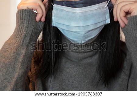 Woman wearing double protective mask
