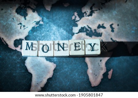 Wooden cube block showing ”MONEY” wording