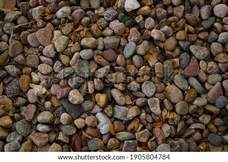 A close-up overhead shot of rounded river-rock gravel.