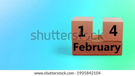 Gradient blue green background with wooden block calendar with date February 14 with copy space and space for your text.