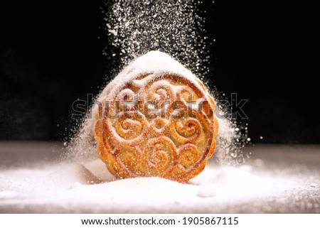 A traditional Chinese moon cake against a black background
