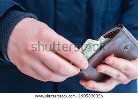 hands pull out hundred-dollar bills from the wallet. High quality photo