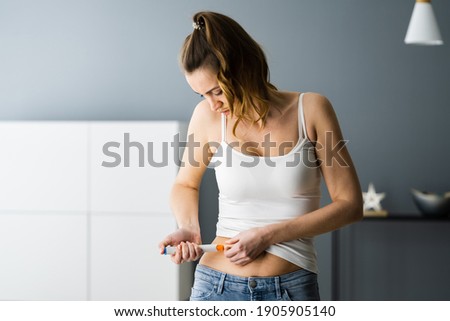 Medicament Self Injection In Belly Using Syringe With Drug Royalty-Free Stock Photo #1905905140