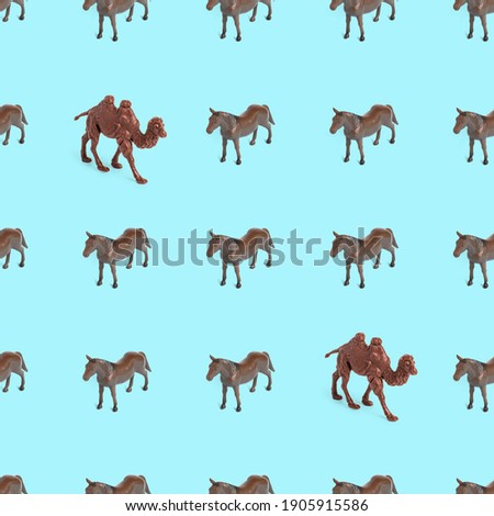 Seamless pattern photo of a toy horse and camel on a blue background creative illustration.