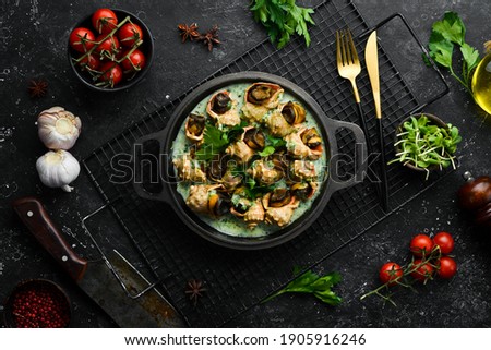 Rapana is cooked in shells with creamy spinach sauce. Luxury restaurant food. Seafood. Rustic style. Flat Lay. Royalty-Free Stock Photo #1905916246