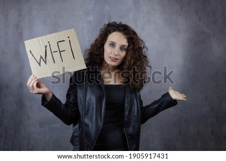 young woman holds a poster with the inscription Wi-Fi