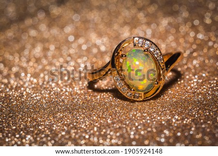 Fashion rose gold ring with a bright rainbow flash opal stone.