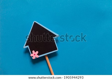 House shape mini chalkboard on blue background. Business concepts