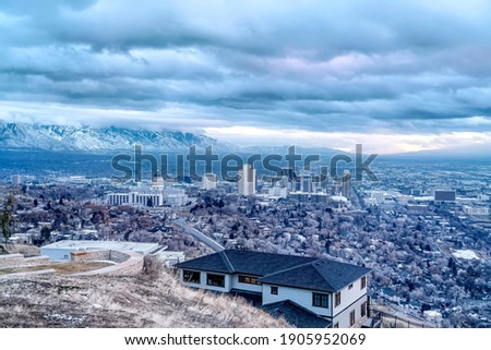 Salt Lake City aerial landscape with snowy mountain and overcast sky views