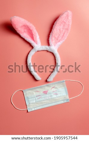 Easter bunny with medical mask on ink background. Easter concept