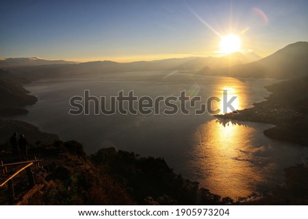 Lake Atitlan, Guatemala - October, 2020: Landscapes of Guatemala. A panoramic view of Lake Atitlan during the sunrise.