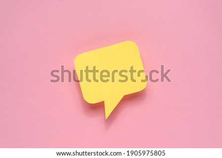 Yellow color speech bubble on light pink background. Copy space.