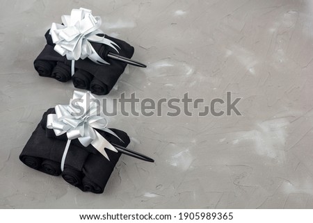 Handmade tanks of socks as gift to men on February 23 on grey background with copyspace