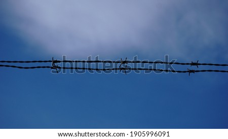 barbed wires against sky background